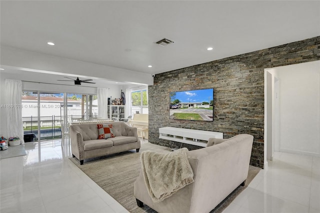 tiled living room featuring ceiling fan