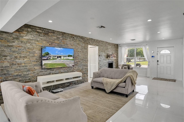 living room with light tile patterned floors and a fireplace