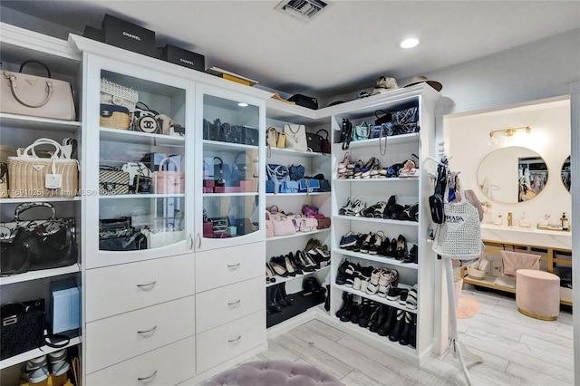 spacious closet featuring light wood-type flooring