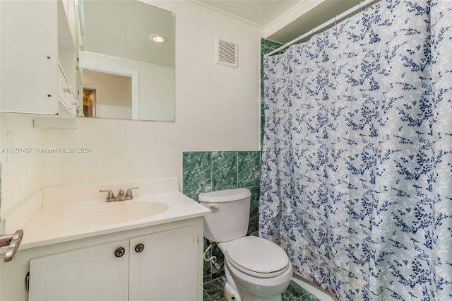 bathroom with ornamental molding, a shower with curtain, vanity, toilet, and tile walls