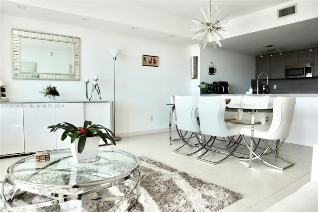 dining area featuring a notable chandelier and sink