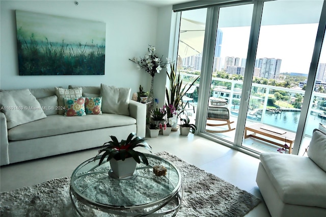 living room featuring concrete flooring and floor to ceiling windows