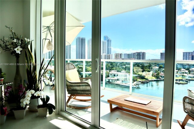 doorway to outside with plenty of natural light and a water view