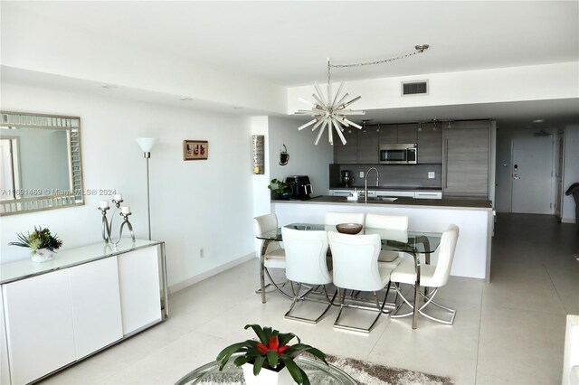 kitchen with sink and a notable chandelier