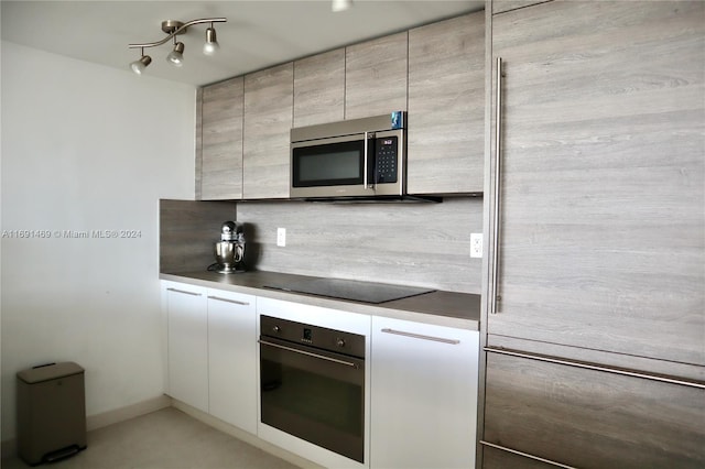 kitchen featuring stainless steel appliances and tasteful backsplash