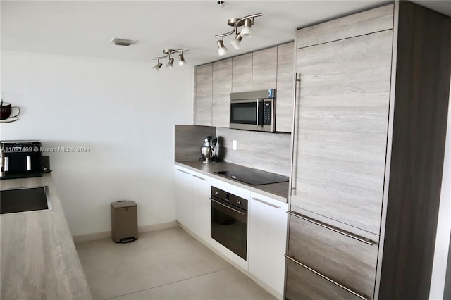 kitchen with white cabinets, sink, and stainless steel appliances