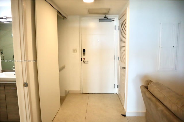 corridor with sink and electric panel