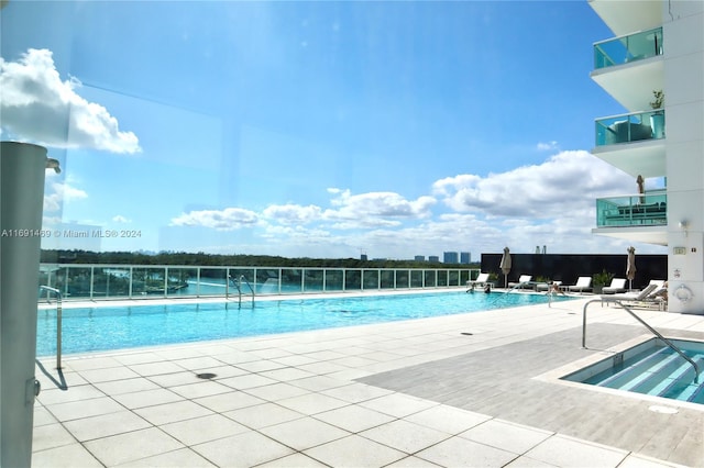 view of swimming pool with a patio