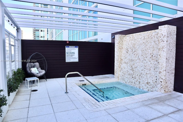 exterior space with a community hot tub and a pergola