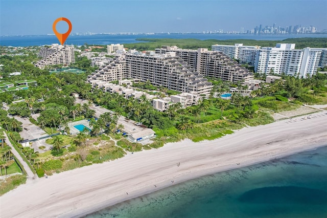 birds eye view of property featuring a beach view and a water view