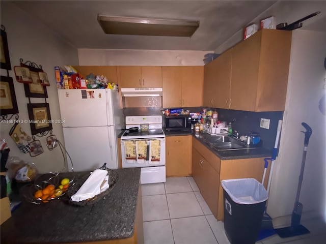 kitchen with light brown cabinetry, sink, light tile patterned floors, and white appliances