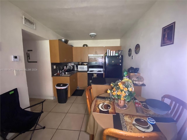 kitchen with backsplash, sink, light tile patterned floors, and white appliances