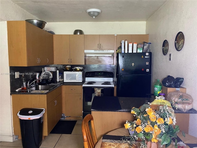 kitchen with light tile patterned floors, white appliances, and sink