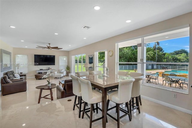 dining space with ceiling fan and a healthy amount of sunlight