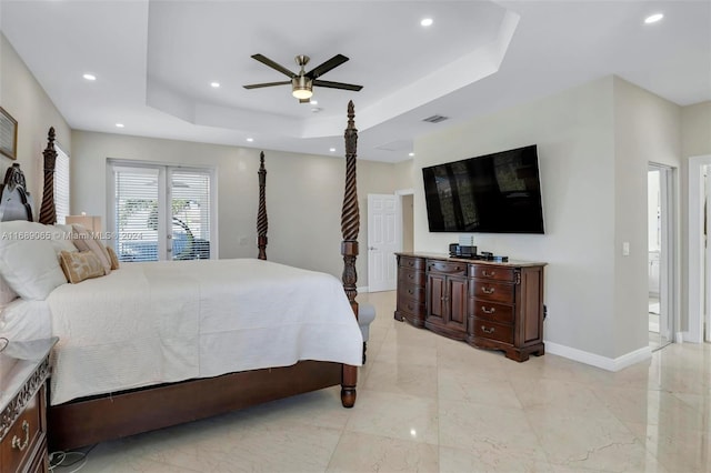 bedroom featuring access to exterior, a tray ceiling, and ceiling fan