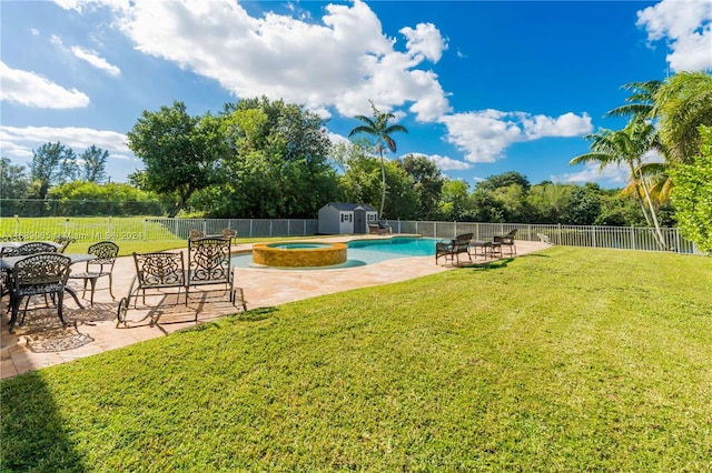 view of yard featuring a patio area, a storage unit, and a pool with hot tub