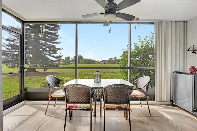 sunroom / solarium featuring ceiling fan