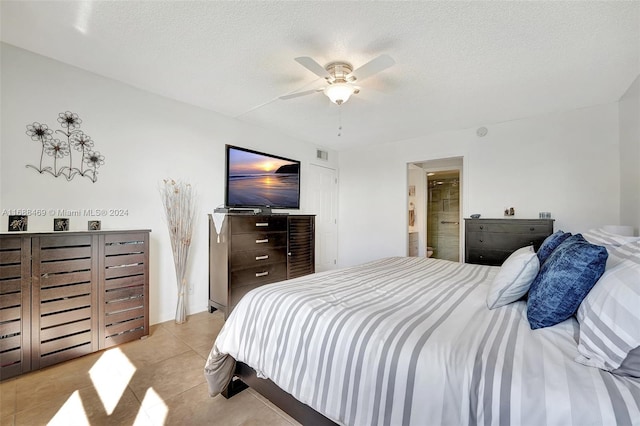 tiled bedroom featuring a textured ceiling and ceiling fan