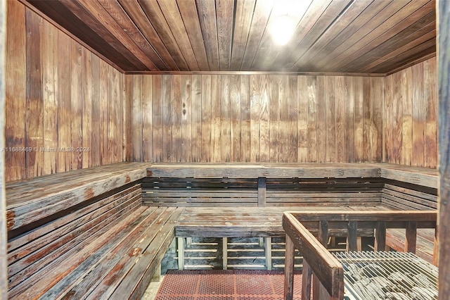 view of sauna featuring wooden walls and wooden ceiling