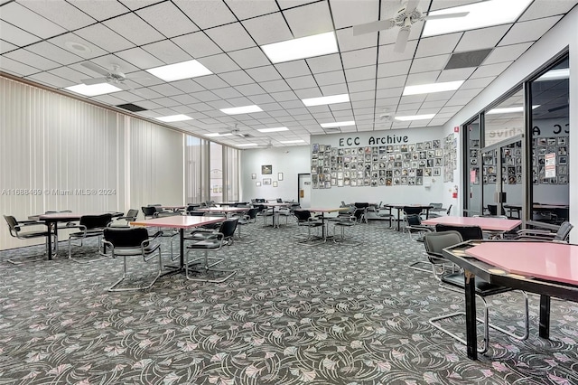 miscellaneous room with a paneled ceiling and carpet