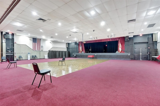 misc room featuring carpet flooring and a drop ceiling