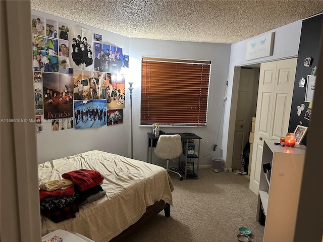 carpeted bedroom with a textured ceiling and a closet