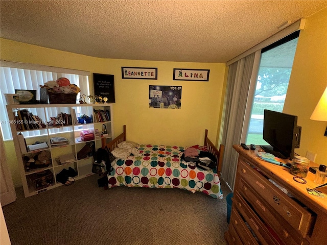 bedroom featuring carpet flooring and a textured ceiling