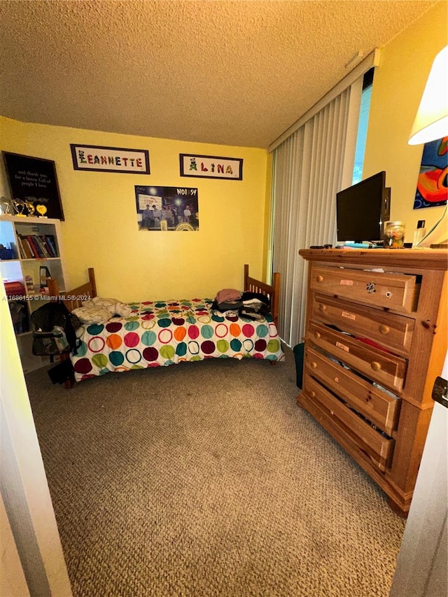 bedroom with a textured ceiling and carpet floors