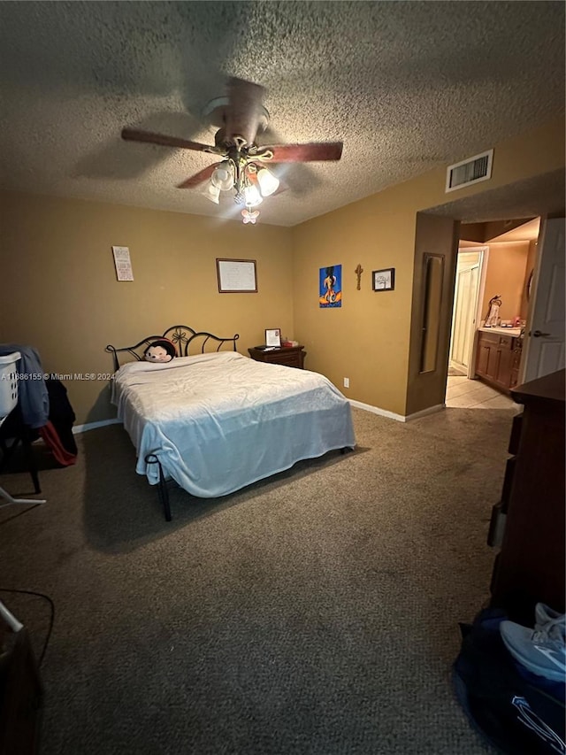 bedroom with a textured ceiling, light carpet, and ceiling fan