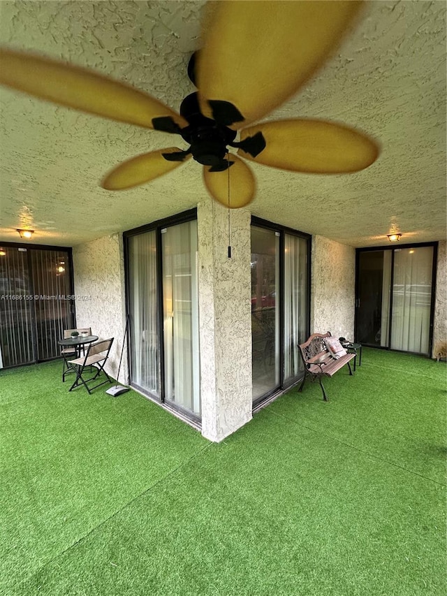 exterior space featuring ceiling fan