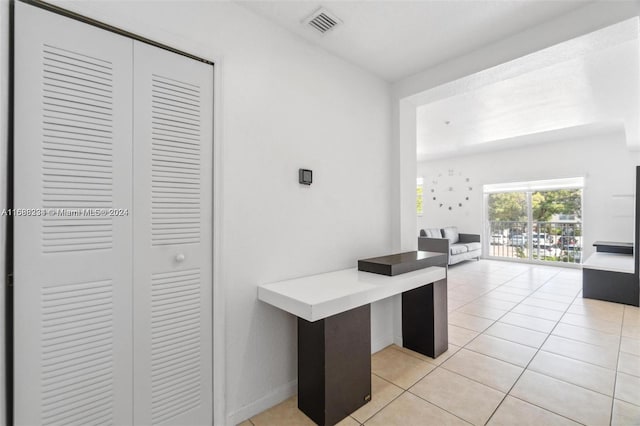 unfurnished office featuring light tile patterned floors