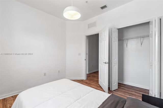 bedroom featuring hardwood / wood-style flooring and a closet