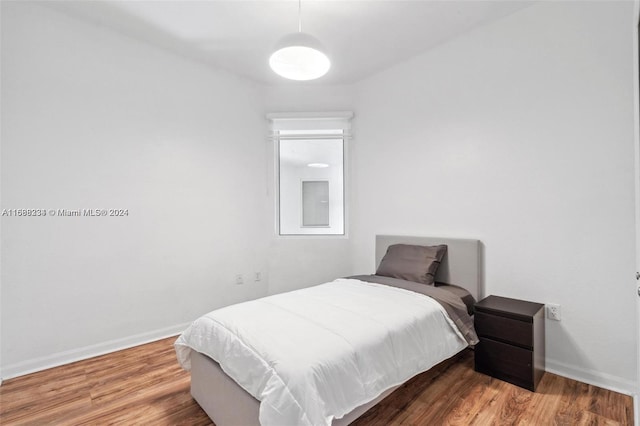 bedroom with hardwood / wood-style flooring