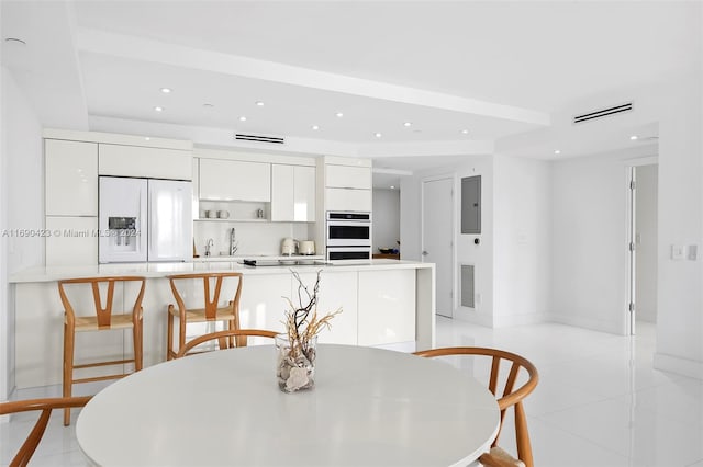 tiled dining space featuring electric panel