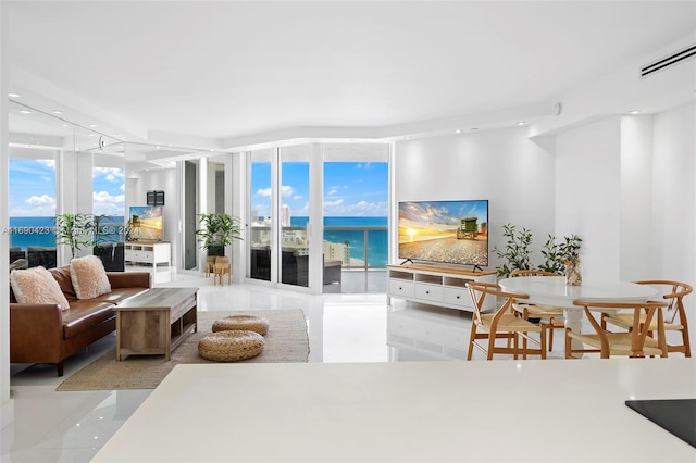 living room featuring a water view and floor to ceiling windows