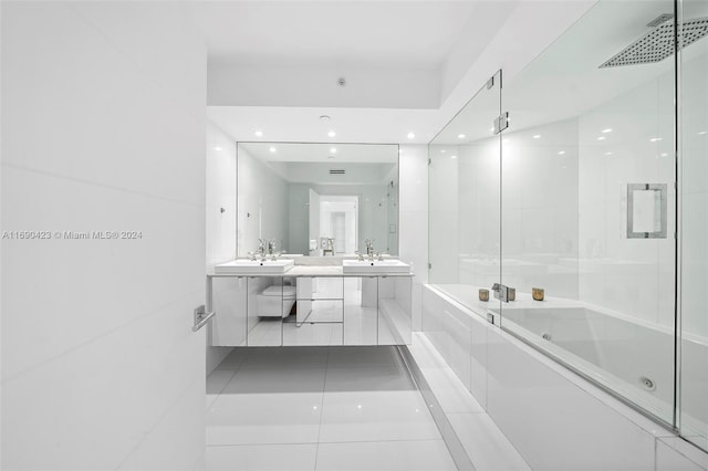 bathroom with tile patterned floors, vanity, and bath / shower combo with glass door