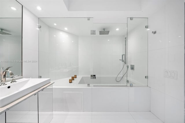 bathroom featuring tile patterned floors, sink, and bath / shower combo with glass door