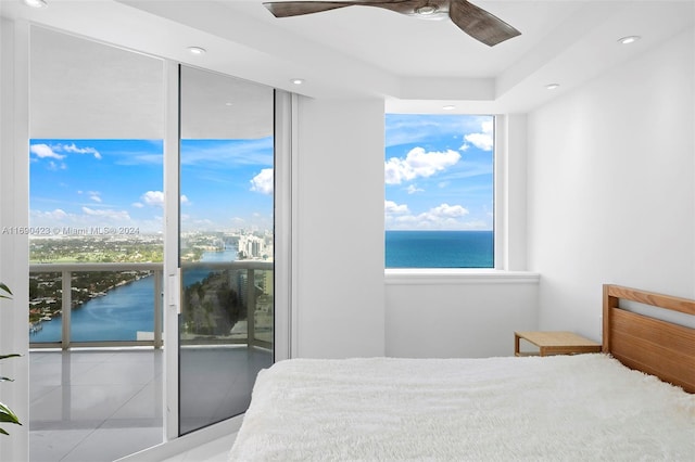 tiled bedroom featuring access to outside, a water view, and ceiling fan