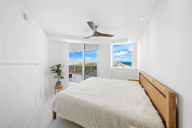 bedroom featuring access to exterior, ceiling fan, and floor to ceiling windows