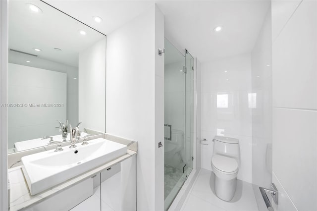 bathroom with tile patterned floors, vanity, toilet, and an enclosed shower