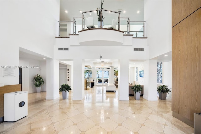 interior space with a towering ceiling and a chandelier