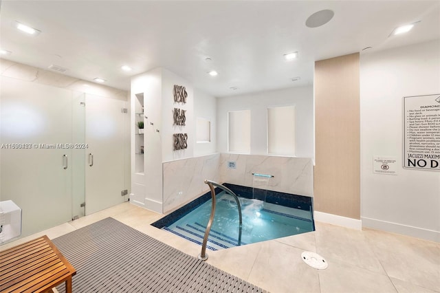 view of swimming pool featuring an indoor hot tub