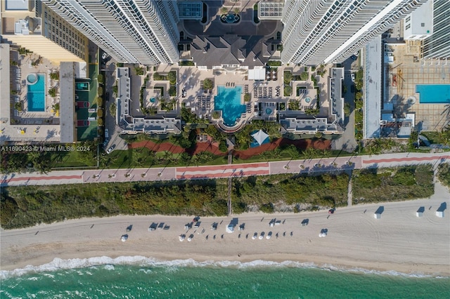 bird's eye view featuring a water view and a view of the beach