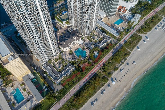 bird's eye view with a water view and a view of the beach