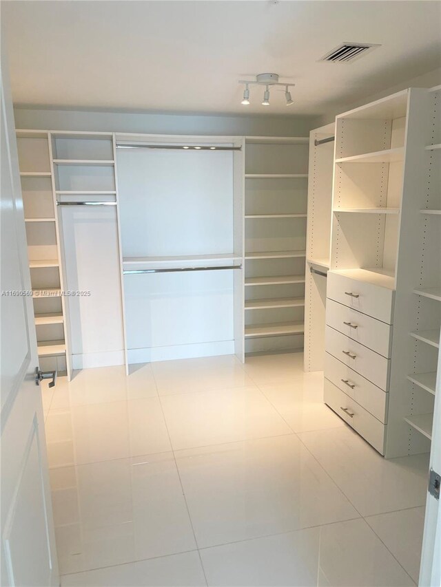 spacious closet featuring light tile patterned floors