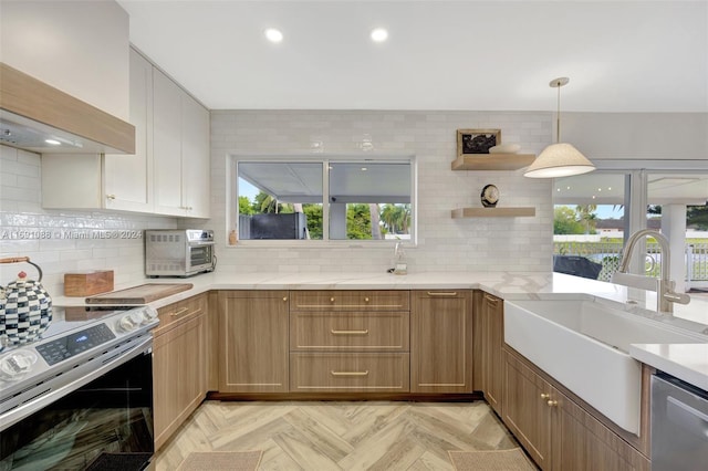 kitchen with extractor fan, stainless steel appliances, light parquet flooring, and plenty of natural light