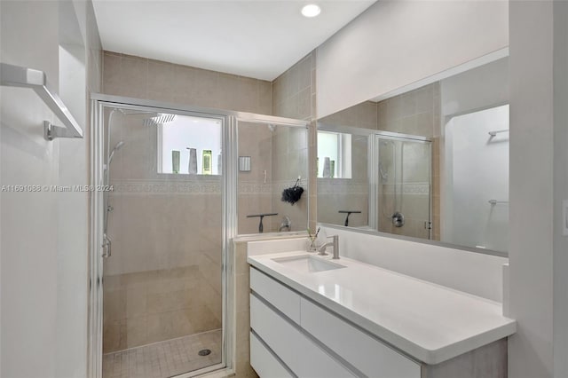 bathroom with vanity and a shower with door