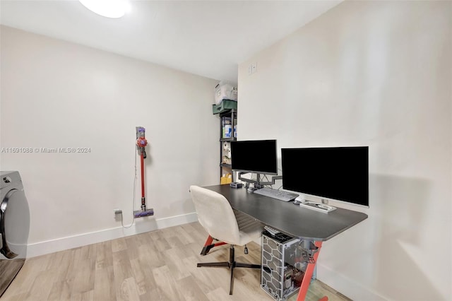 office area featuring washer / dryer and light hardwood / wood-style flooring