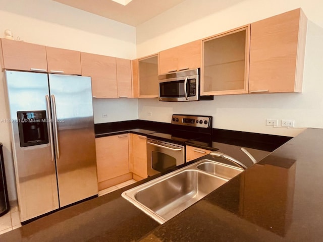 kitchen with stainless steel appliances, sink, and light brown cabinets