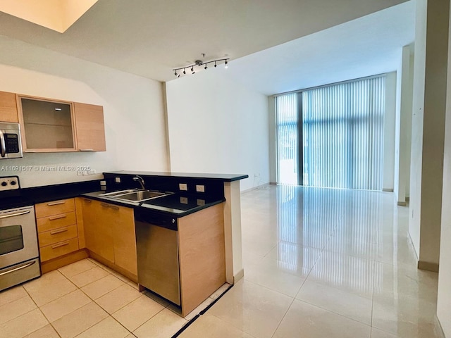 kitchen featuring stainless steel appliances, light tile patterned flooring, sink, and kitchen peninsula